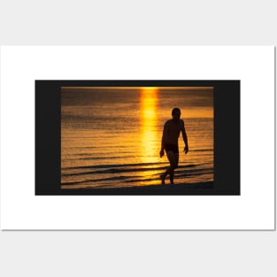 Silhouette of man in the golden light at St KIlda Beach, Melbourne. Posters and Art